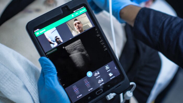 Healthcare worker in ambulance looking at monito